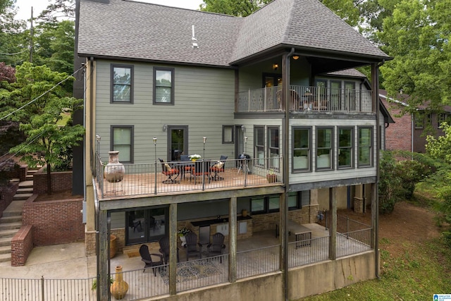 back of property featuring a balcony and a patio