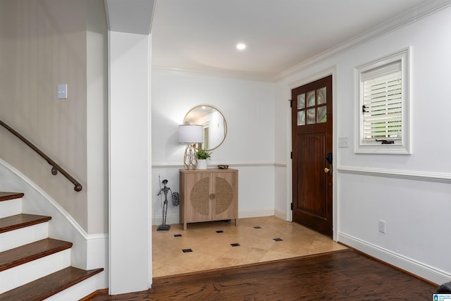 tiled entryway featuring ornamental molding