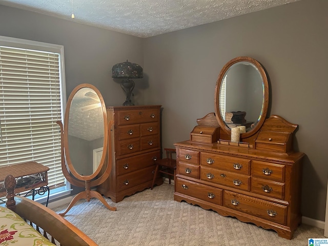 carpeted bedroom featuring a textured ceiling