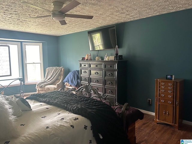 bedroom featuring a textured ceiling, ceiling fan, and dark hardwood / wood-style flooring