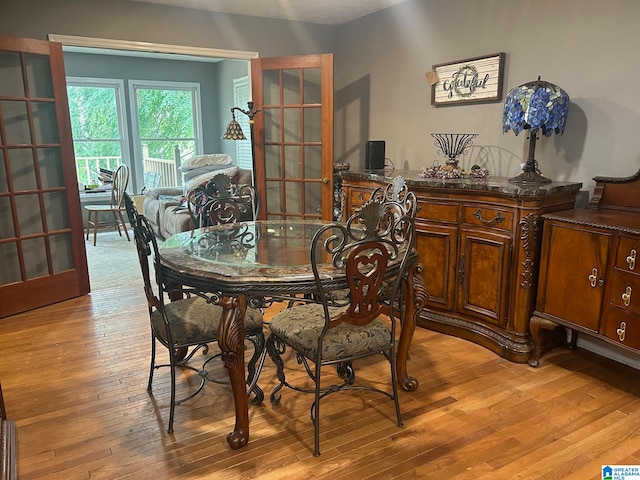 dining area with french doors and light wood-type flooring