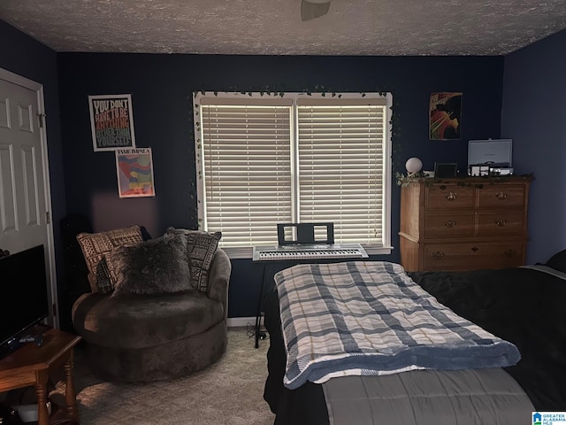 bedroom with a textured ceiling and carpet