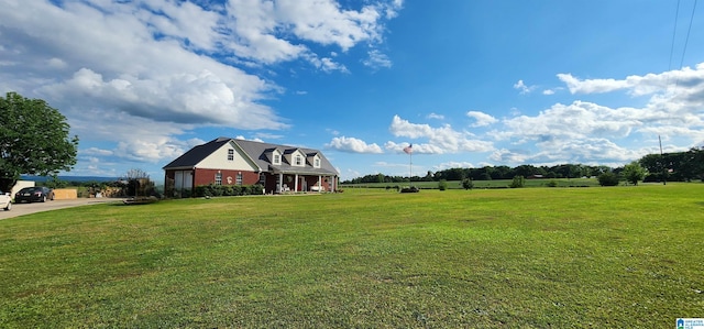 exterior space featuring a front yard and a rural view