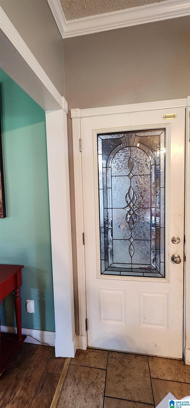 tiled foyer entrance featuring crown molding