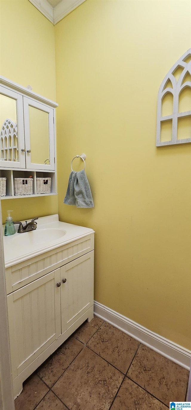 bathroom featuring oversized vanity, ornamental molding, and tile floors