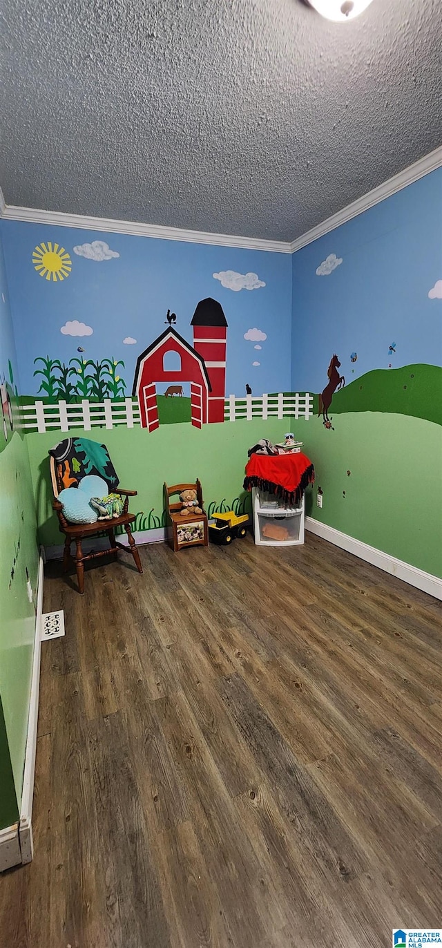 game room featuring ornamental molding, a textured ceiling, and hardwood / wood-style flooring