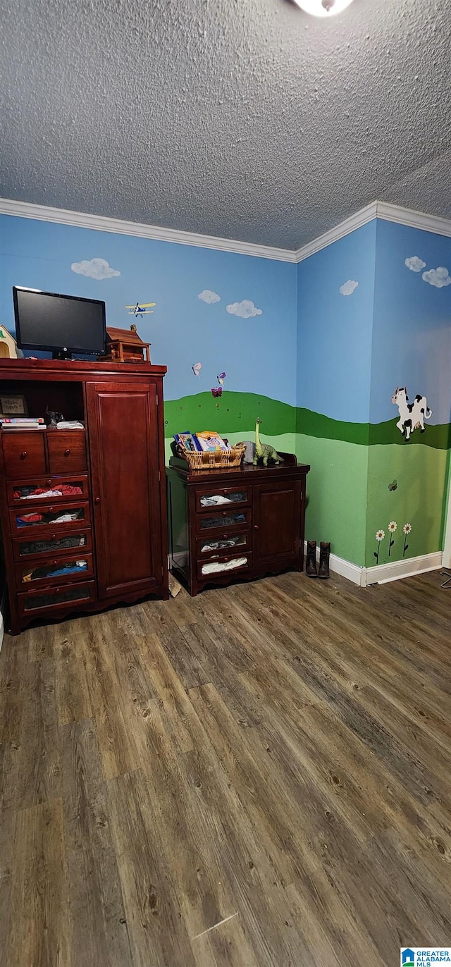 interior space with a textured ceiling, ornamental molding, and hardwood / wood-style floors