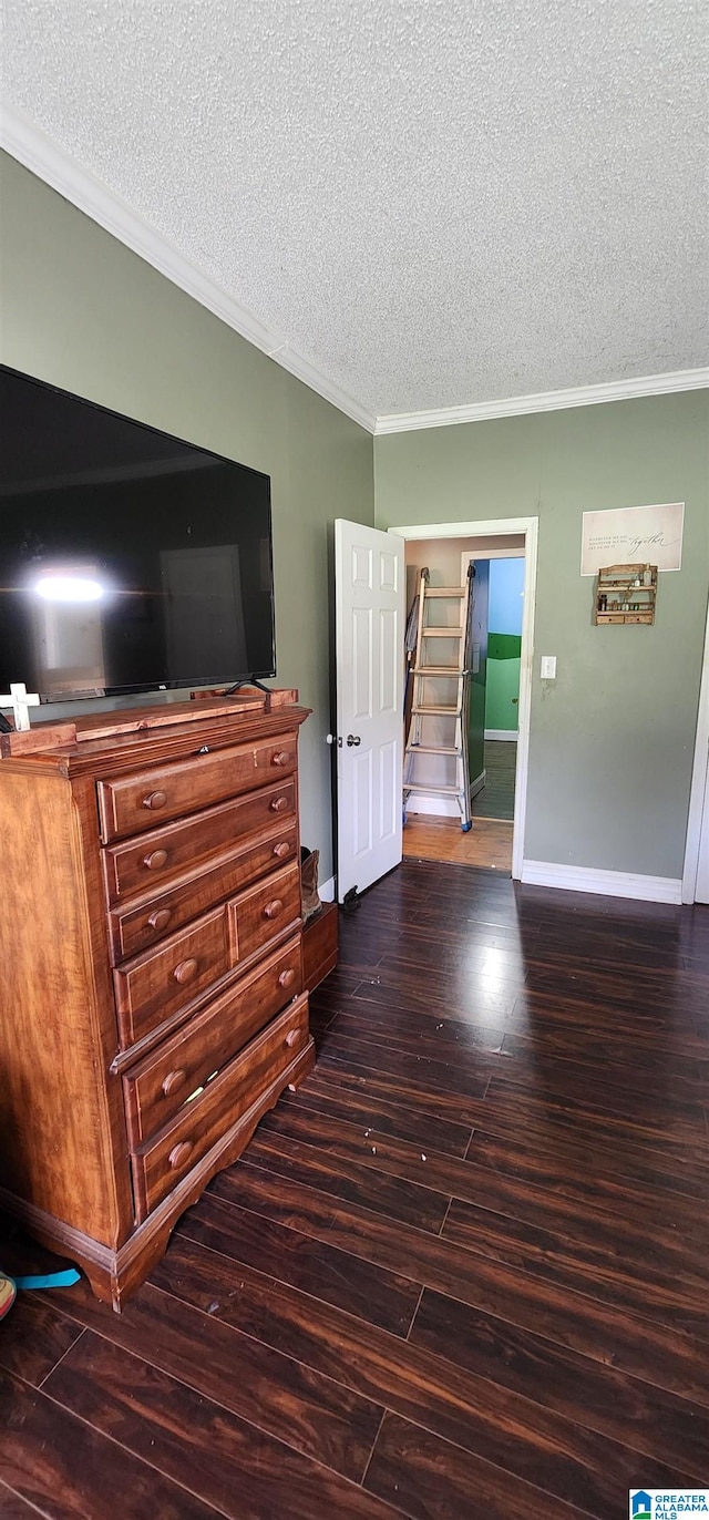 interior space with crown molding, dark hardwood / wood-style flooring, and a textured ceiling