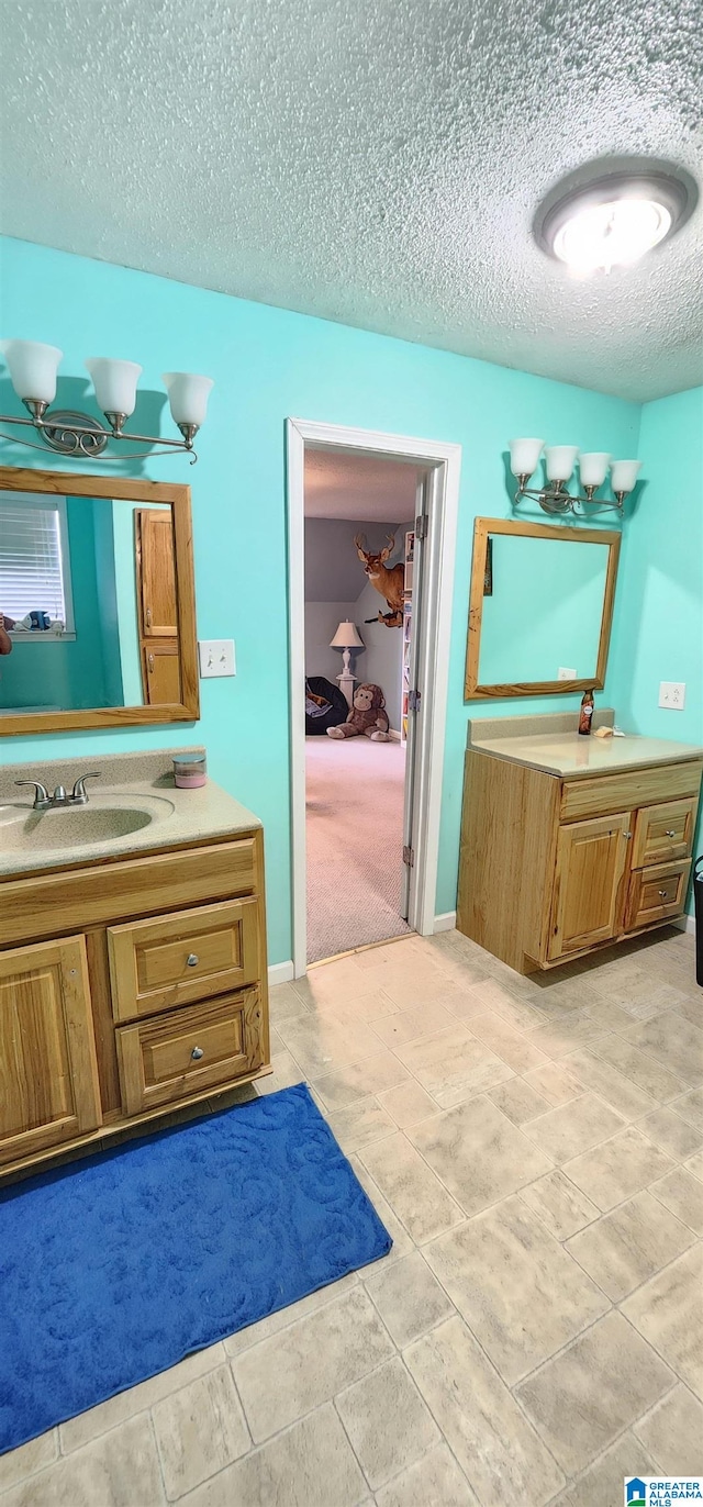 bathroom featuring tile flooring, a textured ceiling, and vanity