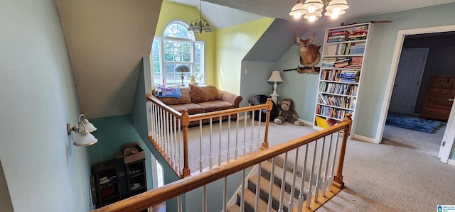 interior space with an inviting chandelier, carpet floors, and lofted ceiling