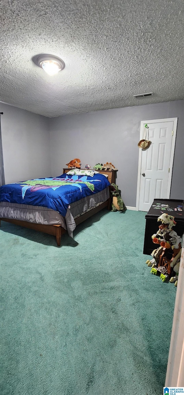 unfurnished bedroom featuring a textured ceiling and carpet