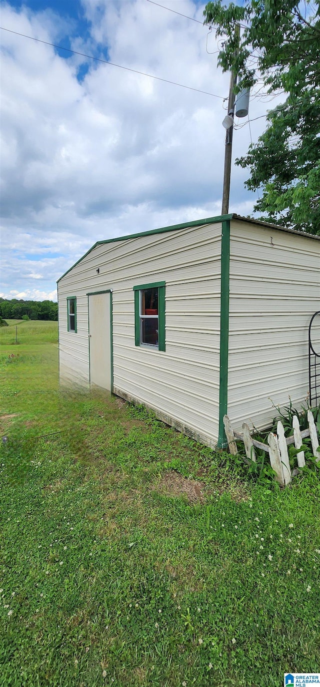 view of shed / structure with a lawn