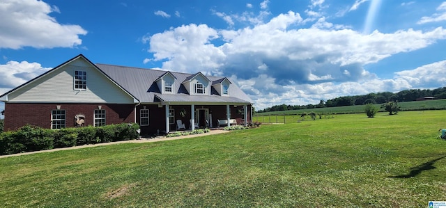 cape cod home with a front yard and a rural view