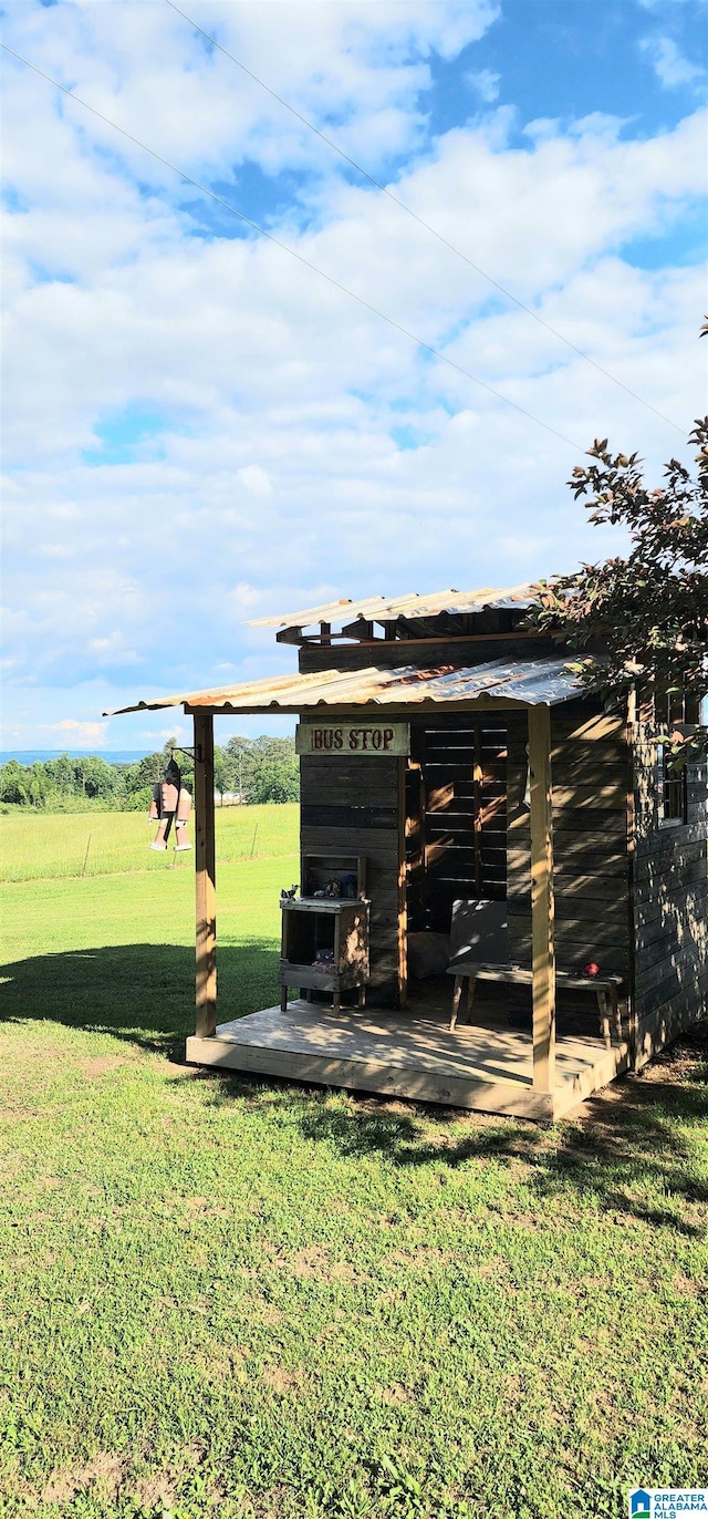 view of outdoor structure with a yard and a rural view