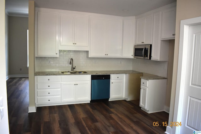 kitchen with dark wood-type flooring, appliances with stainless steel finishes, white cabinets, light stone counters, and sink