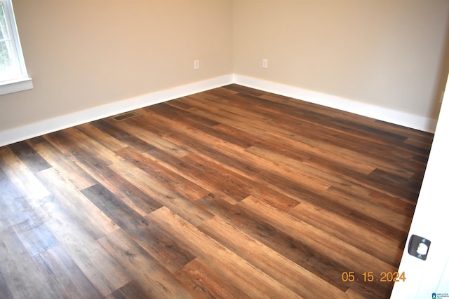 empty room featuring dark hardwood / wood-style flooring