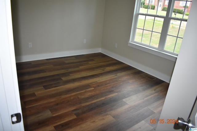 unfurnished room with dark hardwood / wood-style floors