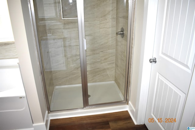 bathroom featuring walk in shower and hardwood / wood-style flooring