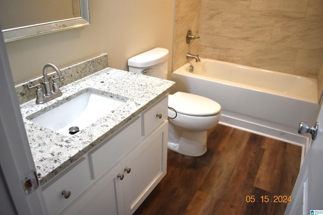 full bathroom featuring shower / bathtub combination, wood-type flooring, toilet, and vanity