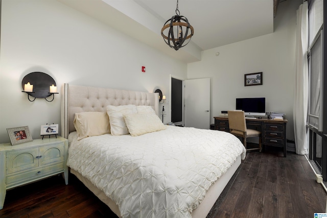 bedroom with a chandelier and dark hardwood / wood-style flooring