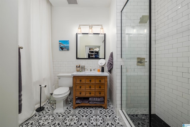 bathroom featuring tasteful backsplash, oversized vanity, an enclosed shower, tile floors, and toilet