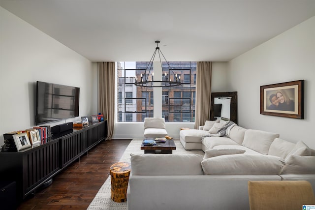 living room with a chandelier and dark wood-type flooring