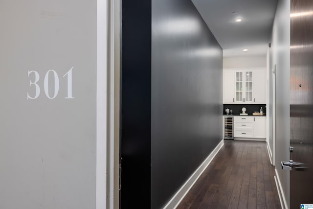 corridor with wine cooler and dark hardwood / wood-style flooring