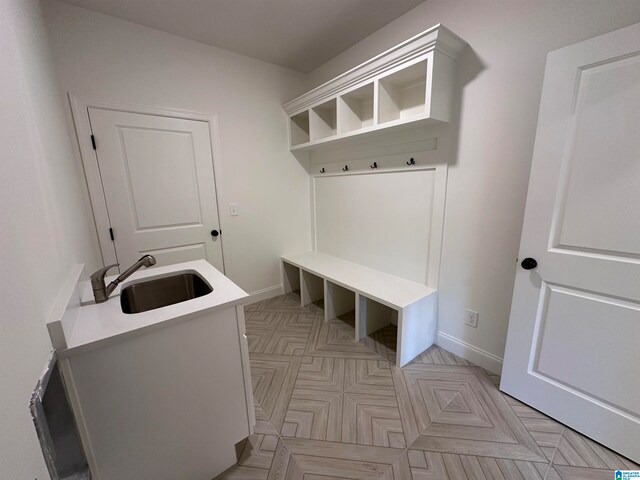 mudroom with sink and light parquet floors