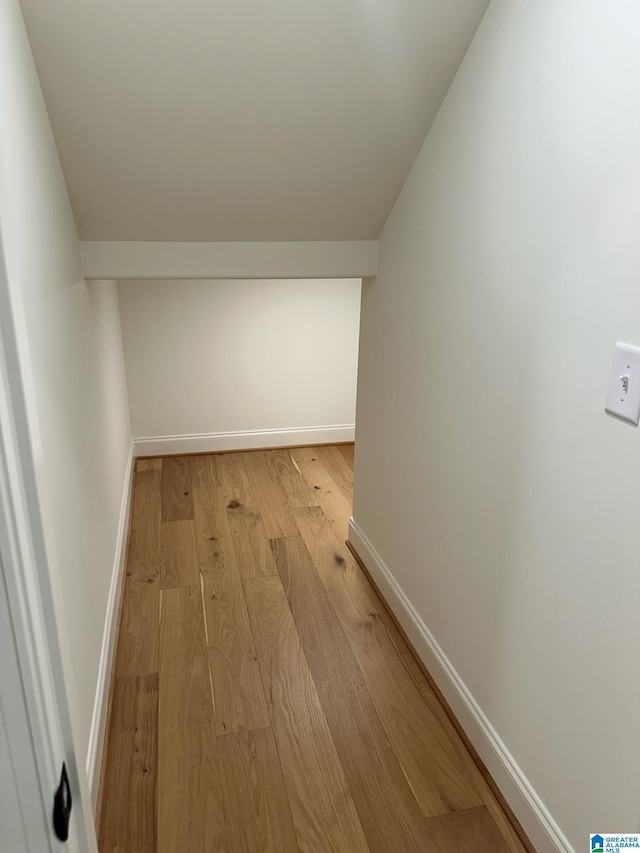 corridor with light hardwood / wood-style flooring