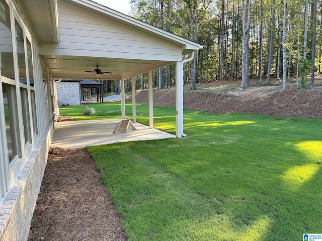 view of yard with a patio and ceiling fan