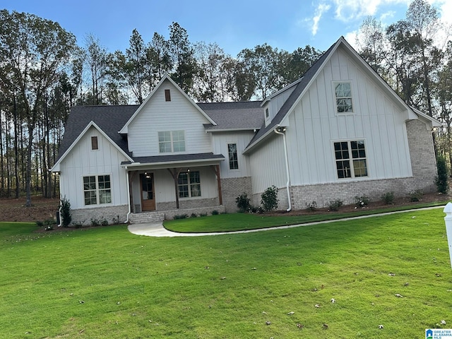 modern farmhouse featuring a front lawn and covered porch