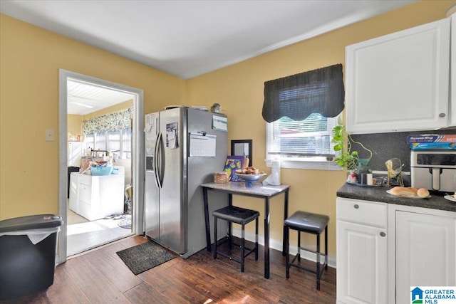 kitchen featuring white cabinets, stainless steel fridge with ice dispenser, dark hardwood / wood-style floors, and washer / dryer