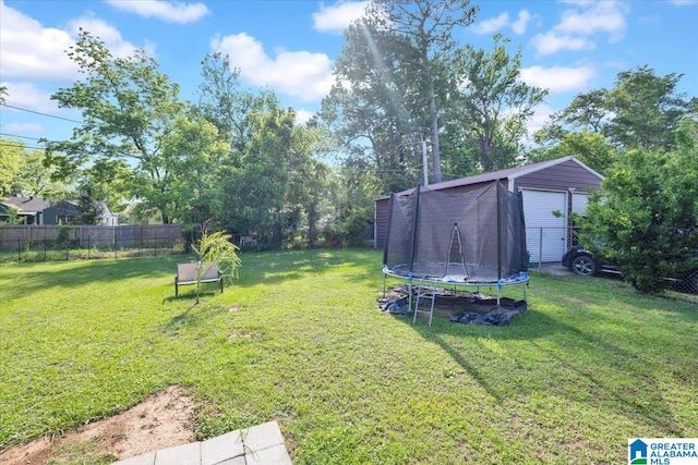 view of yard featuring an outdoor structure and a trampoline