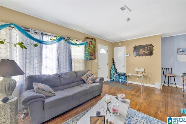 living room featuring crown molding and hardwood / wood-style flooring