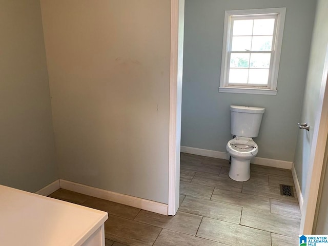 bathroom featuring toilet and tile floors