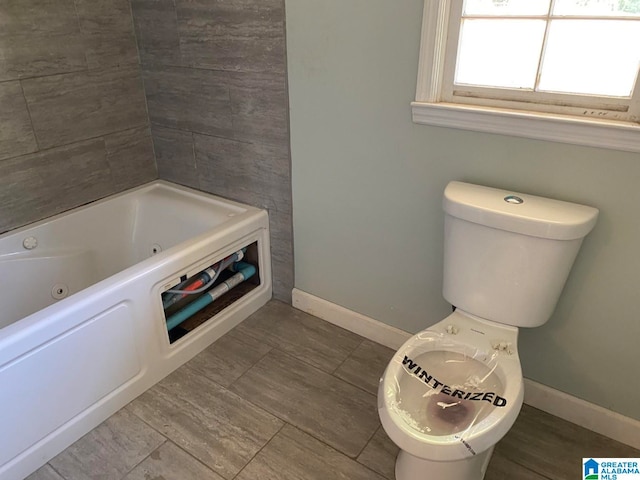 bathroom featuring tile flooring and toilet