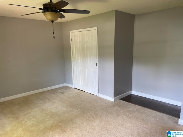 unfurnished bedroom featuring carpet flooring, a closet, and ceiling fan