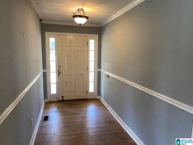 foyer entrance with a healthy amount of sunlight, a textured ceiling, dark hardwood / wood-style floors, and crown molding