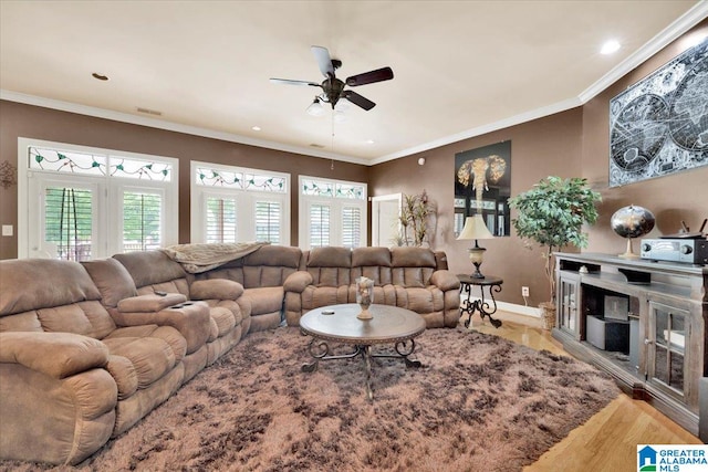 living room featuring ceiling fan, light wood-type flooring, and ornamental molding