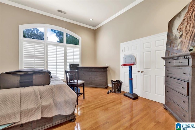 bedroom featuring light hardwood / wood-style floors and ornamental molding