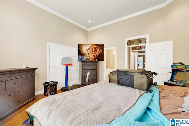 bedroom with crown molding and light hardwood / wood-style floors