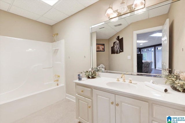 bathroom featuring shower / bathtub combination, a drop ceiling, vanity, and tile patterned floors