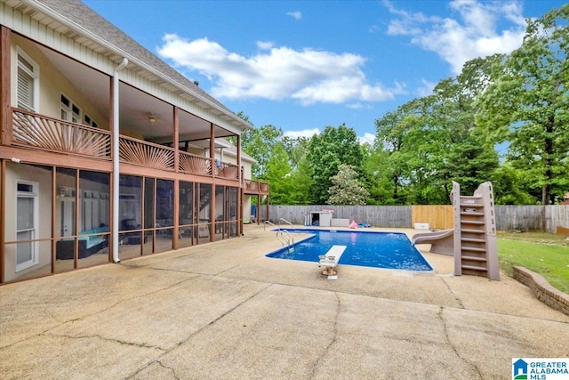 view of pool featuring a diving board and a patio area