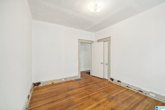 spare room with hardwood / wood-style flooring