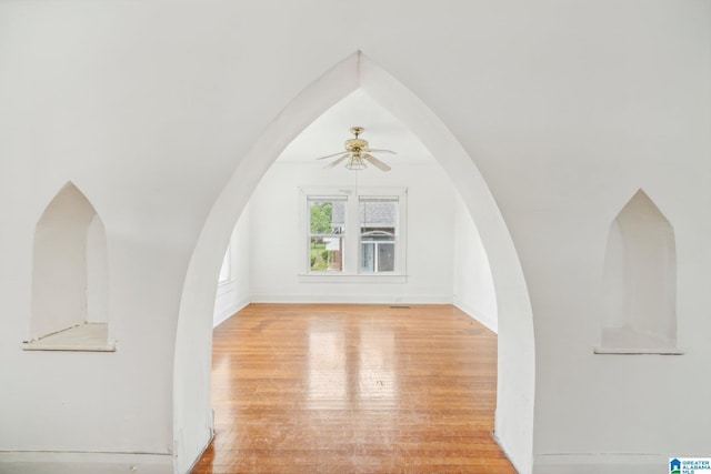 bonus room with light wood-type flooring and ceiling fan