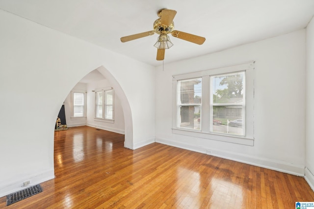 unfurnished living room with hardwood / wood-style flooring, plenty of natural light, and ceiling fan