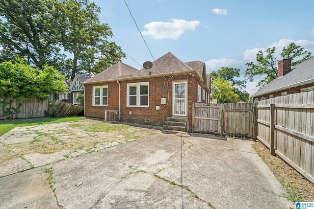 back of house with central air condition unit and a patio