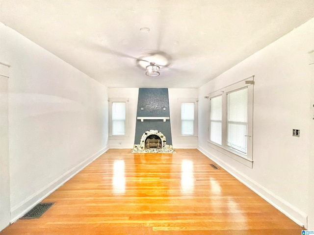 unfurnished living room featuring a fireplace and light hardwood / wood-style flooring