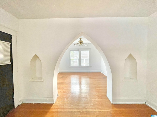 unfurnished living room featuring light hardwood / wood-style floors and ceiling fan