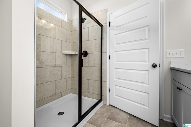 bathroom with vanity, tile patterned flooring, and a shower with door